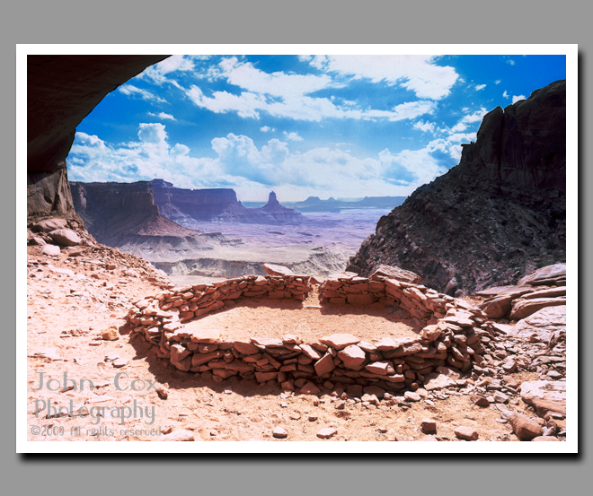 Ancient Native American ruins sit sheltered below an alcove overlooking Canyonlands National Park.