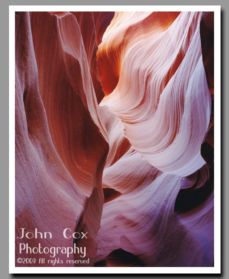 Sandstone striations glow brightly inside the narrow slot canyon of Lower Antelope Canyon.